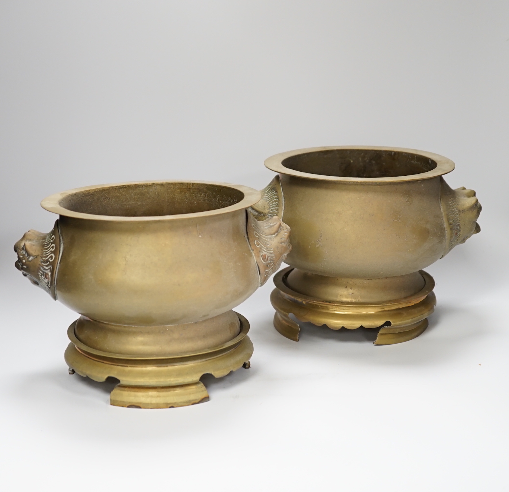 A pair of Chinese bronze lion mask censers and stands, 18cm high